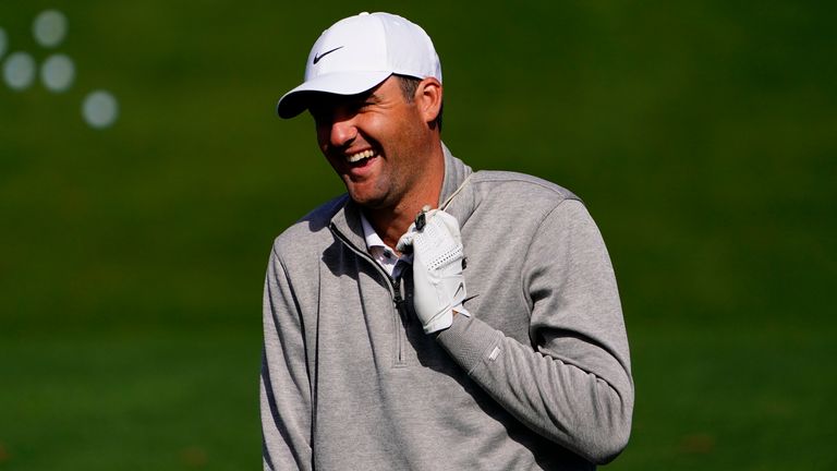 Scottie Scheffler laughs while on the driving range during a practice round for the Masters