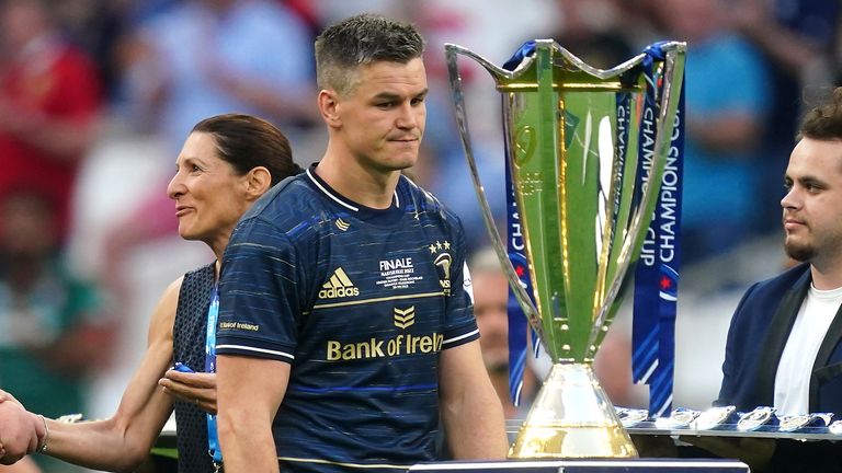 Johnny Sexton passes the Heineken Champions Cup trophy after final defeat 