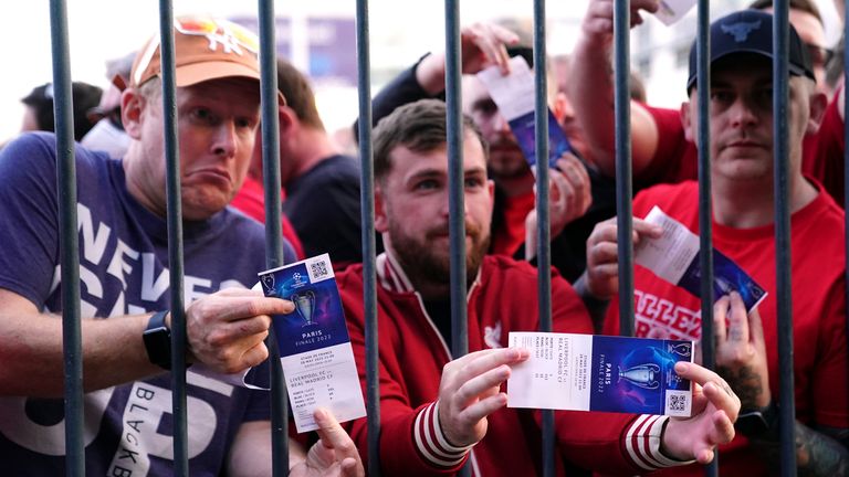 Liverpool supporters show their tickets as they struggled to get into the Champions League final
