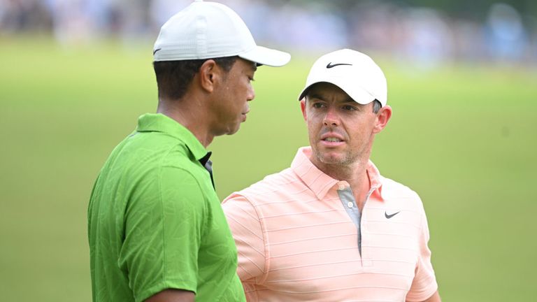 Woods played alongside Rory McIlroy (right), who fell five off the lead after a one-over 71 