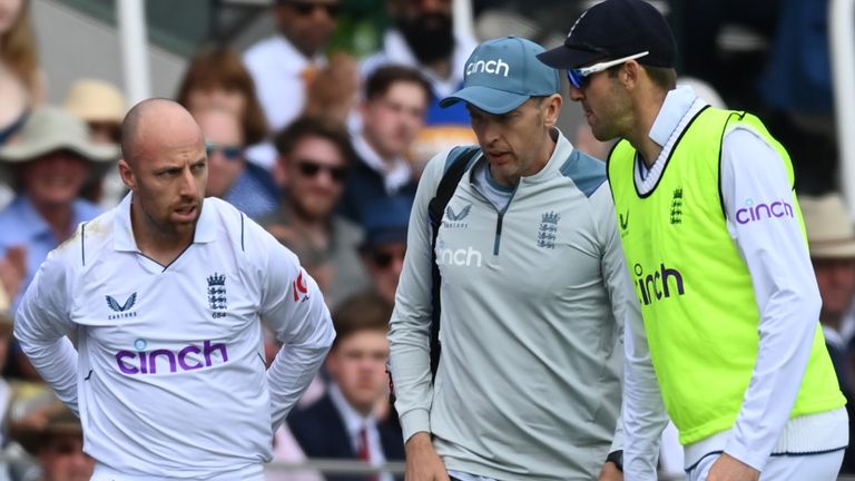 Jack Leach is escorted from the field after suffering a concussion while fielding