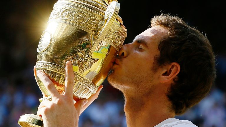 Murray kisses the trophy after winning his first Wimbledon title in 2013