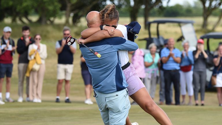 Jessica Baker hugs her dad, who is also her caddy, after winning the Women's Amateur Championship in Hunstanton