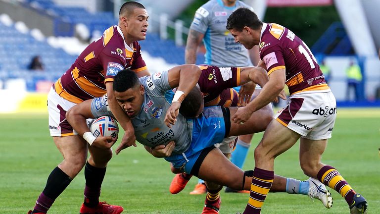 Leeds Rhinos' David Fusitu'a is tackled by Huddersfield Giants' Tui Lolohea, Josh Jones and Jack Cogger 