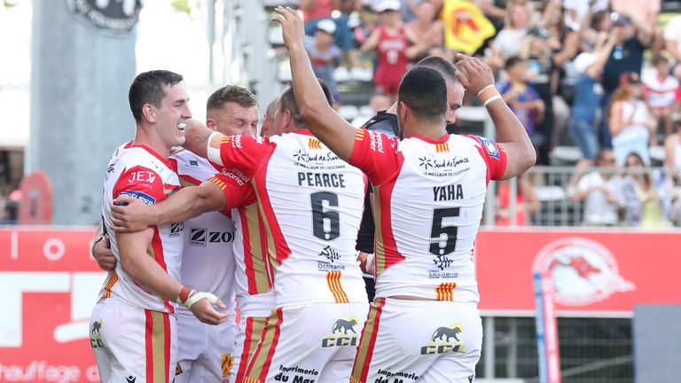Josh Drinkwater celebrates with his Dragons team-mates after scoring a try