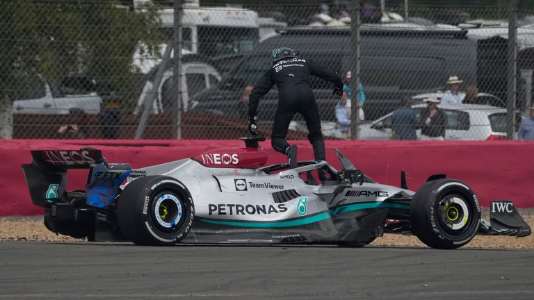 Mercedes driver George Russell jumps out of his car after first corner crash