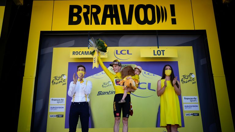 Vingegaard wearing the overall leader's yellow jersey as he celebrates on the podium after the 20th stage of the Tour de France 