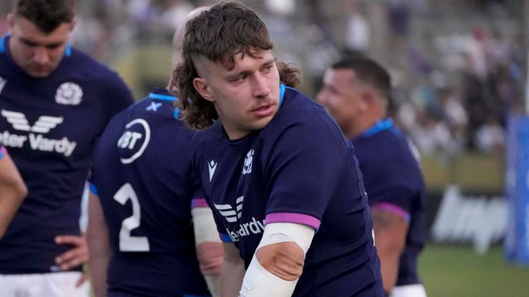 Scotland's Kyle Rowe looks on at the end of the game with his arm in a sling and supporting himself with crutches