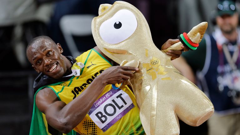 Usain Bolt celebrates winning gold in the men's 100m final during the athletics in the Olympic Stadium
