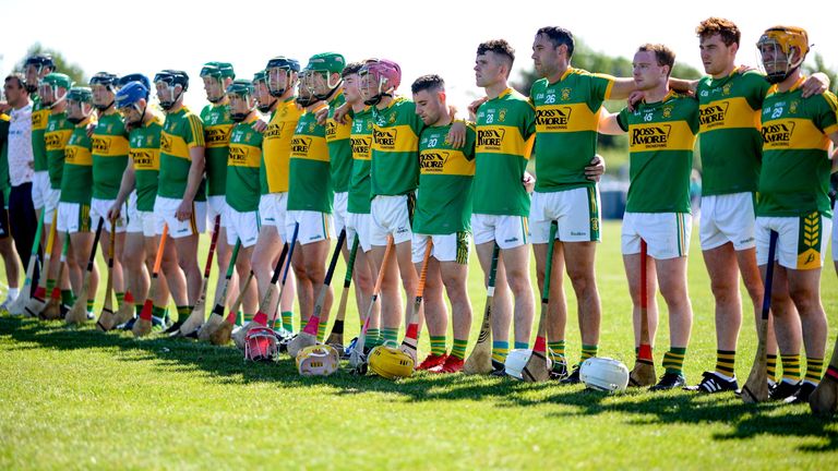 Clonoulty Rossmore players stand for a minutes silence in memory of the late Dillon Quirke prior to the match