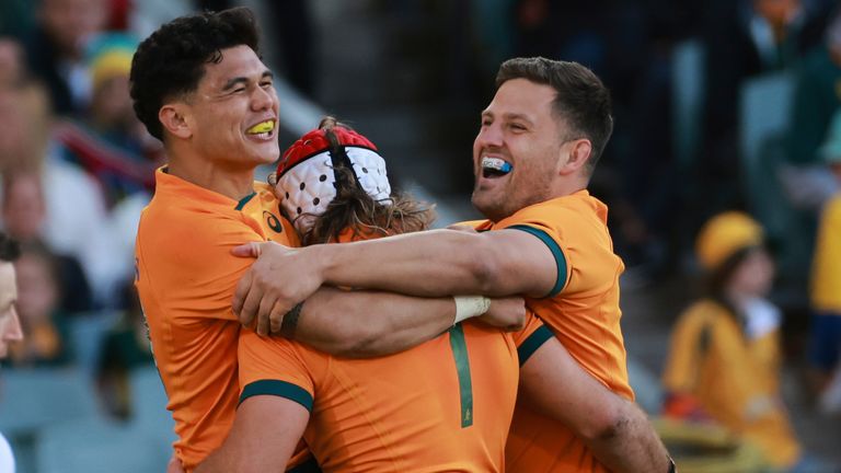 Fraser McReight (centre) is congratulated by teammates Noah Lolesio (left) and David Porecki after scoring