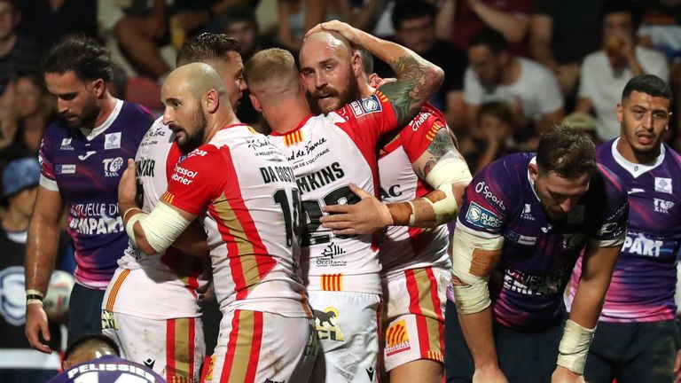 Catalans celebrate Gil Dudson's try while Toulouse's players look on dejected