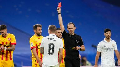 Real Madrid's Toni Kroos is shown a red card