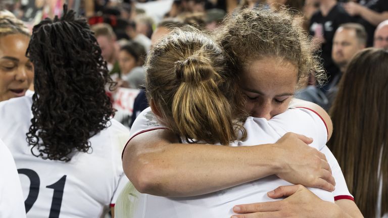 England's Abby Dow consoles Thompson (No 14) after the World Cup final loss at Eden Park 
