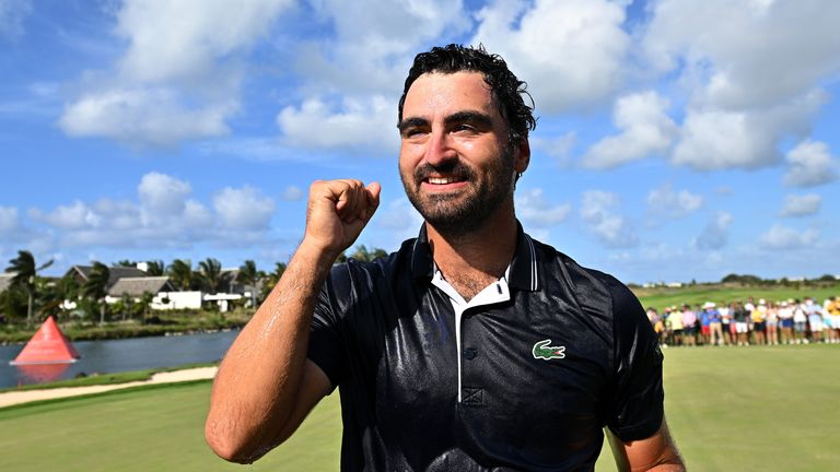 Antoine Rozner smiles despite a celebratory soaking from his caddie in the wake of victory at the Mauritius Open
