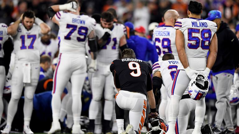 Buffalo Bills team-mates and Cincinnati Bengals players gathered together as Damar Hamlin was treated by medical staff on the field