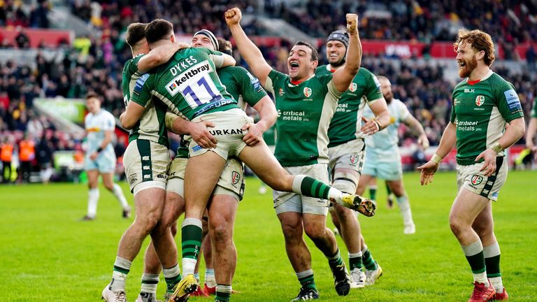 London Irish's Michael Dykes celebrates with teammates after scoring one of his three tries