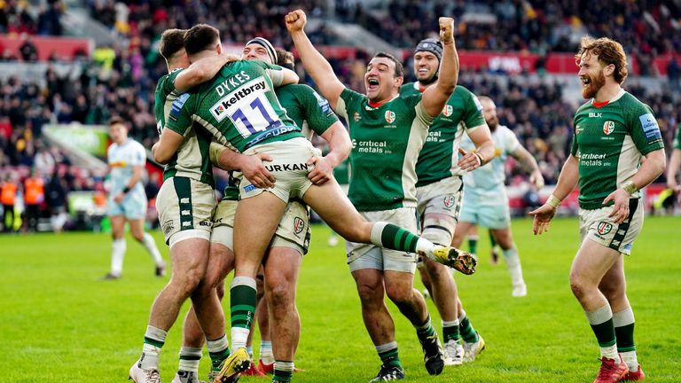 London Irish's Michael Dykes celebrates with his team-mates after scoring one of his three tries