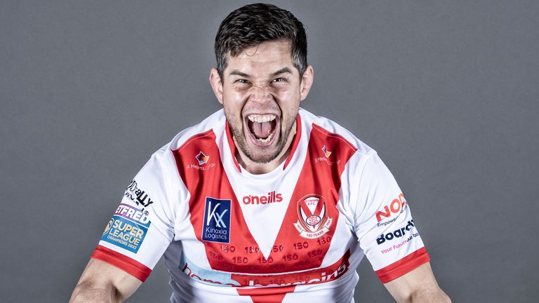 Louie McCarthy-Scarsbrook shows off the 2023 home shirt of reigning Super League champions St Helens