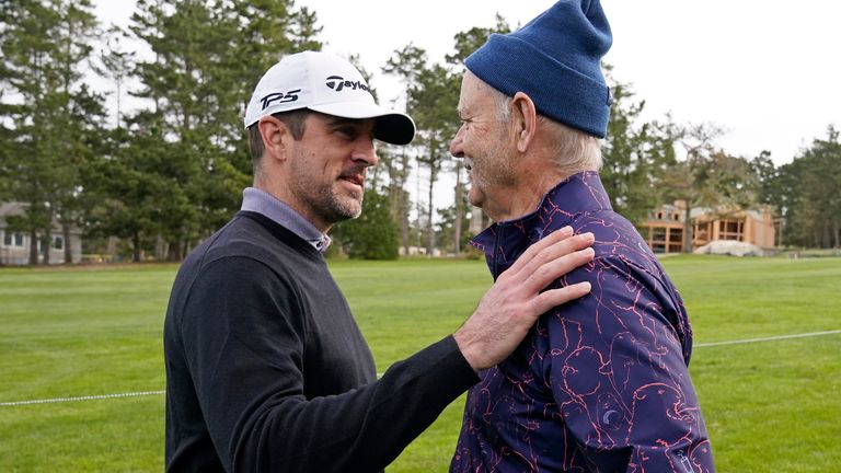Aaron Rodgers (left) greets actor Bill Murray on the sixth fairway of the Spyglass Hill Golf Course