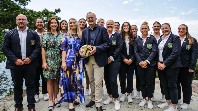 Australian PM Anthony Albanese, Minister for Sport Anika Wells, Wallaroos head coach Jay Tregonning and members of the women's rugby union team pose ahead of the announcement