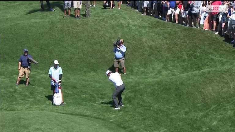 Scottie Scheffler chips in a stunning hole-out from the rough to take the lead at 10 under