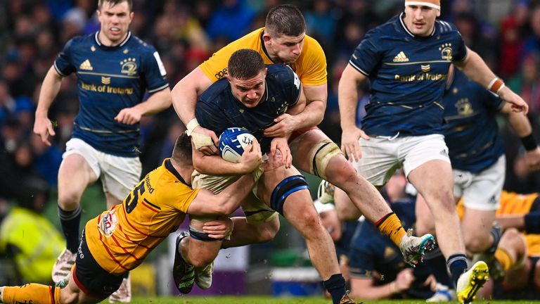 Scott Penny is tackled by Mike Lowry and Nick Timoney