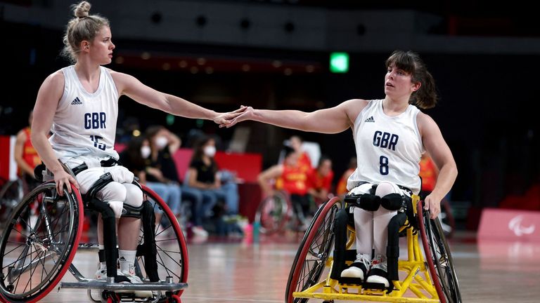 Britain's Robyn Love (L) and Laurie Williams touch hands during the Tokyo 2020 Paralympic Games