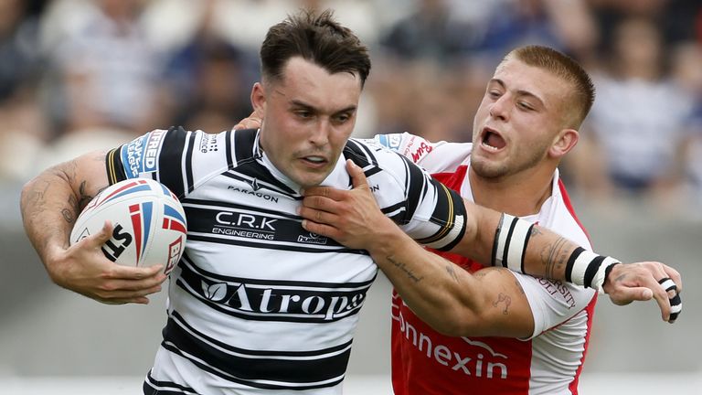 Hull KR's Mikey Lewis does his best to stop Tex Hoy of Hull FC (PA Images)