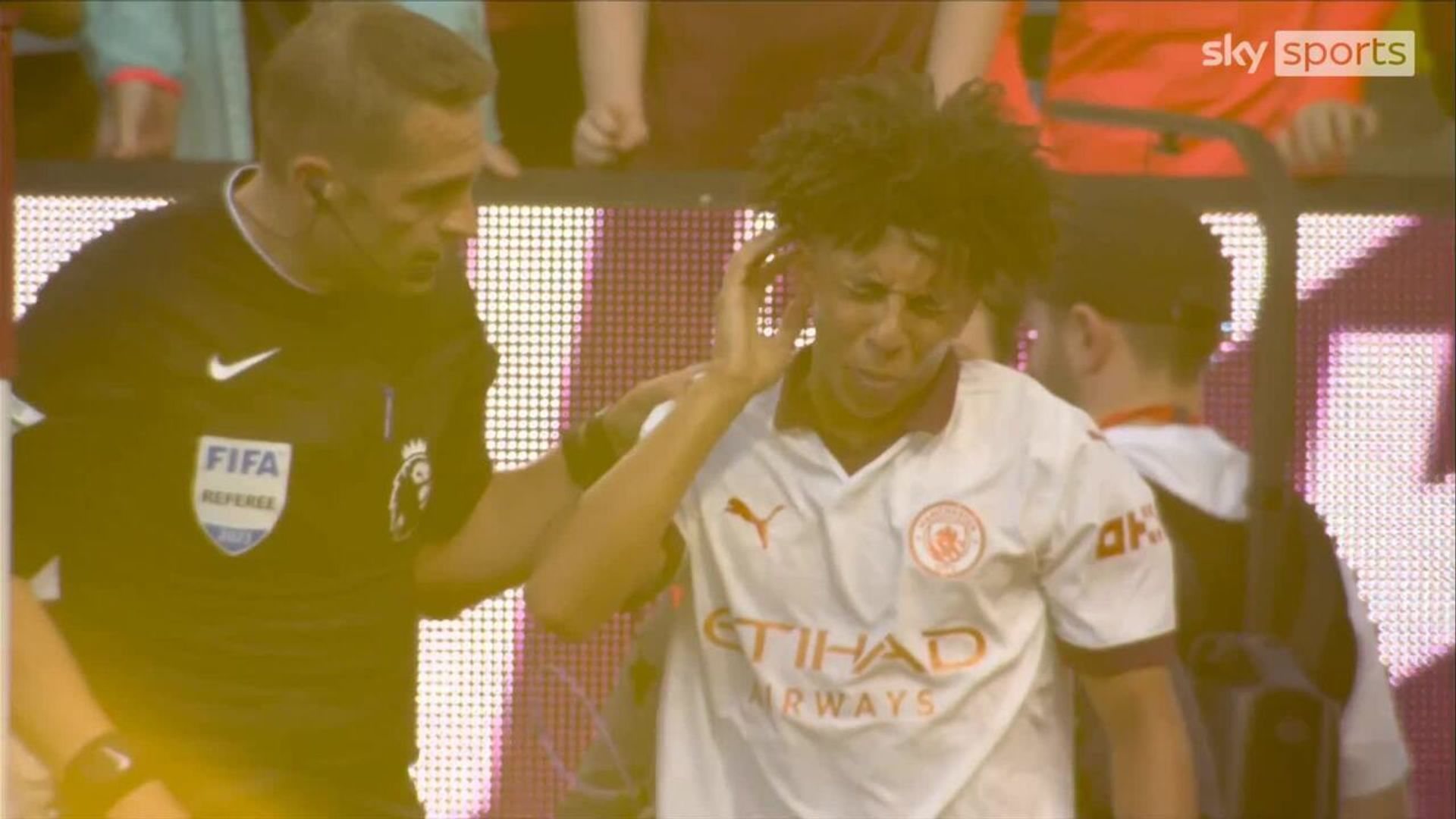 Man City's Lewis appears to be hit by lighter from crowd
