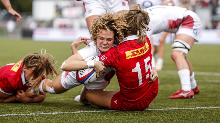 England's Ellie Kildunne scores a try despite pressure from Canada's Sophie de Goede (left) and Madison Grant (right) during the second Test match at StoneX Stadium