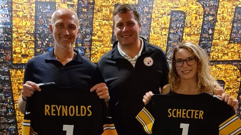 Sky Sports NFL's Neil Reynolds and Phoebe Scheckter are presented with Daniel Rooney's Steelers jerseys