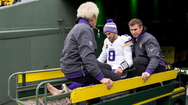 Minnesota Vikings quarterback Kirk Cousins (8) is carted off the field after sustaining an injury against the Green Bay Packers