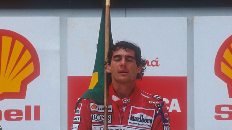 Ayrton Senna raises the Brazilian flag after his first home victory