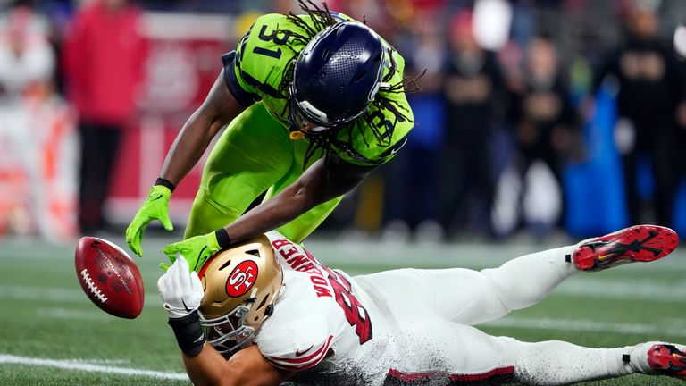 San Francisco 49ers tight end Charlie Woerner attempts to recover the punt return fumble by Seattle Seahawks' DeeJay Dallas during the first half