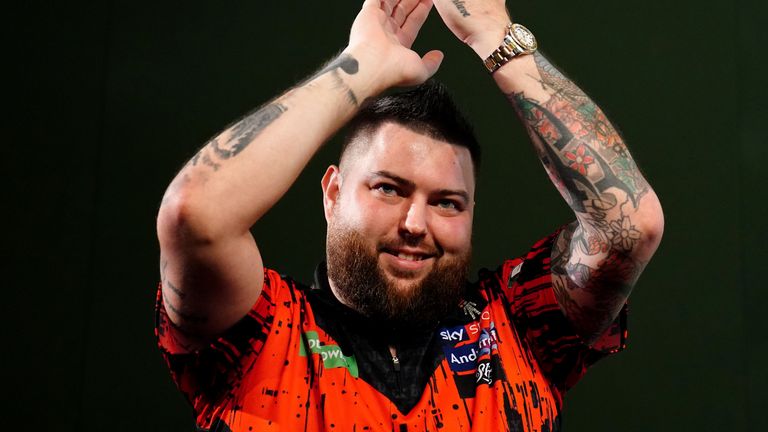 Michael Smith celebrates his second-round comeback win over Kevin Doets at the World Darts Championship