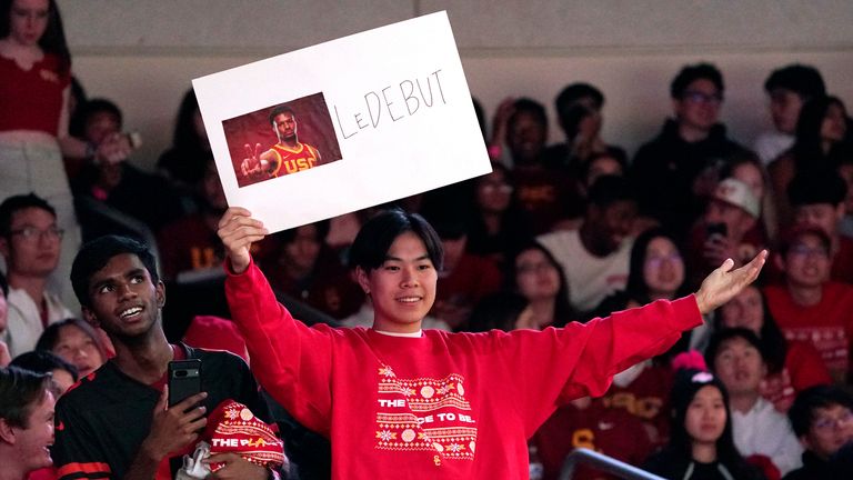 A fan holds up a sign for Bronny James ahead of USC's game