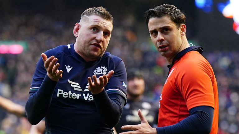 Scotland's Finn Russell speaks to assistant referee Nika Amashukeli as they wait for the dramatic late TMO decision 