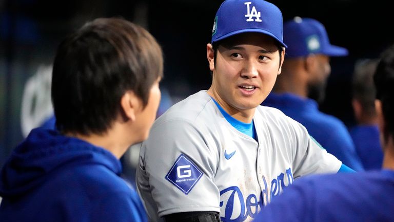 Los Angeles Dodgers' Shohei Ohtani (right) right, talks with interpreter Ippei Mizuhara (left)