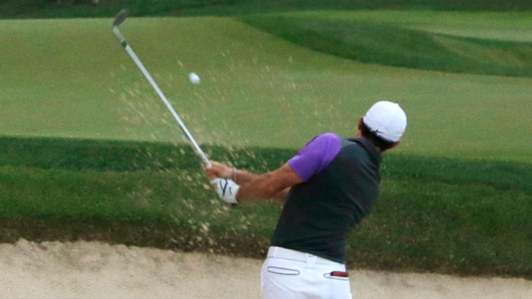 McIlroy recovered from finding a greenside bunker to see out a fourth major victory in 2014