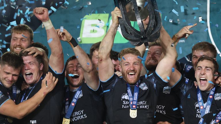 Glasgow Warriors players celebrate with the trophy after winning the United Rugby Championship final in South Africa