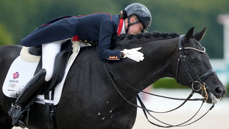 Britain's Charlotte Fry pats Glamourdale during the dressage team Grand Prix final 