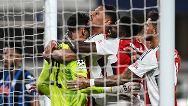 David Raya celebrates with his Arsenal team-mates after his penalty double save against Atalanta