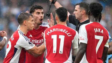 Arsenal players protest as Leandro Trossard is sent off by referee Michael Oliver