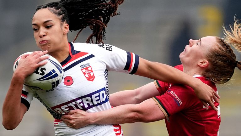 England's Amelia Brown fends Wales' Dani McGifford off in the tackle