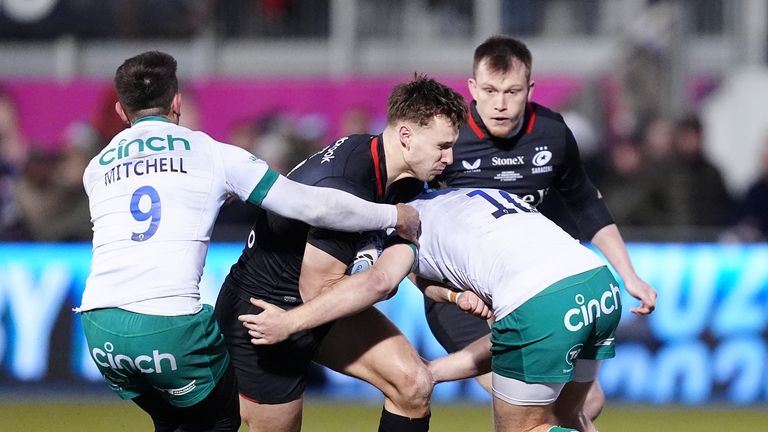 Tobias Elliott (centre) is tackled by Northampton's Alex Mitchell (left) and Fin Smith