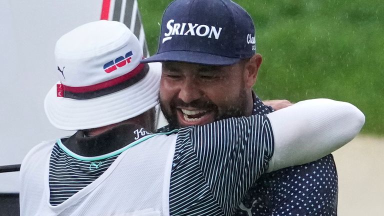 Spaun celebrates by hugging his caddie, Mark Carens, after his tournament-winning birdie at Oakmont