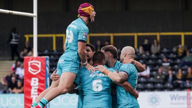 Huddersfield players celebrate Tui Lolohea’s try