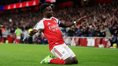 Bukayo Saka does a knee-slide celebration after scoring Arsenal's second