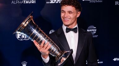 Lando Norris poses with the F1 Drivers' Championship trophy